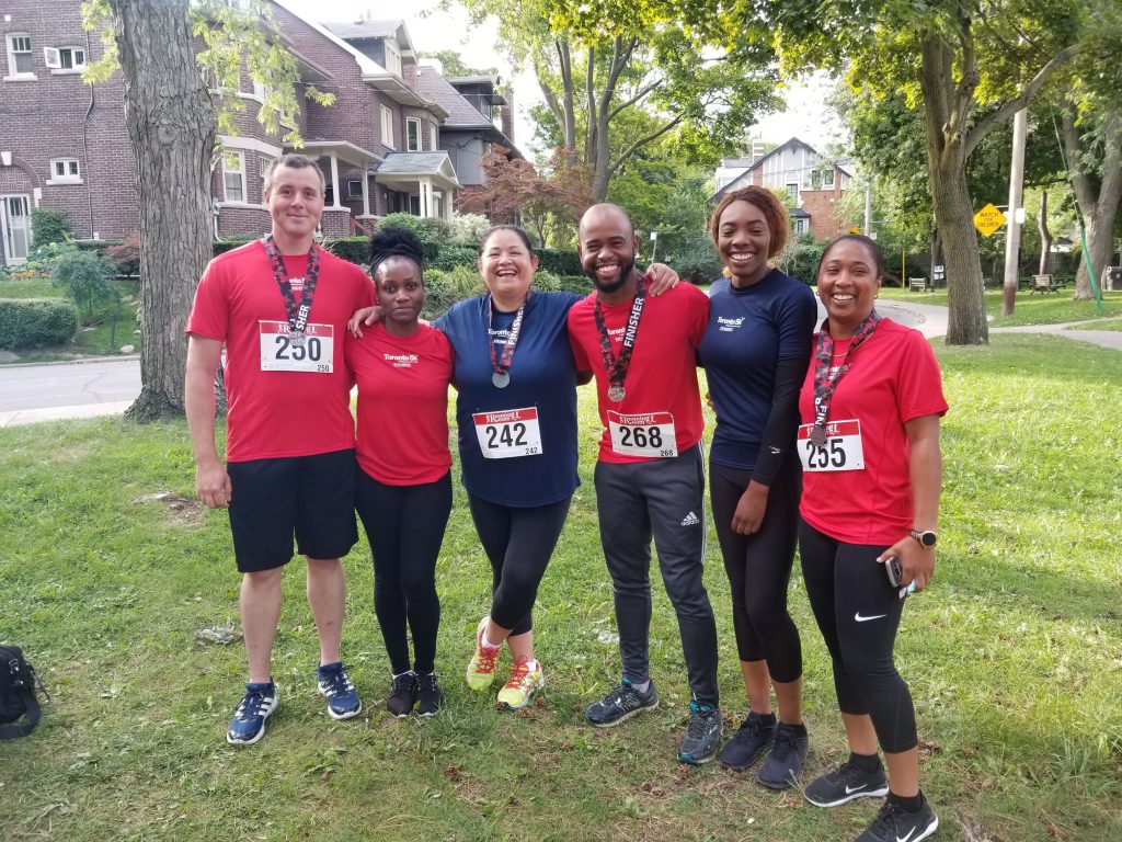 Informative Image shows a team of six mutiVIEW employees posing for a picture after completing the 5/K run/walk to support the Sick Kids Foundation.
